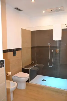a bathroom with a shower and a toilet and a sink at Villa del Principe in Carini