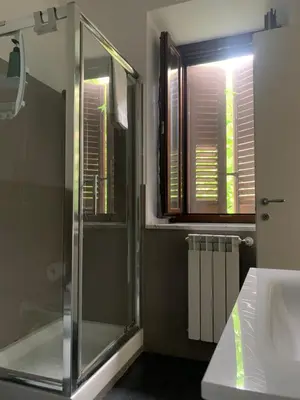 a bathroom with a shower and a sink and a window at Zanclea in Palermo