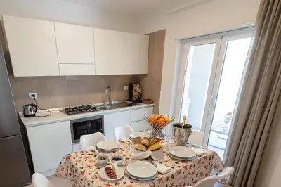 a kitchen with a table with food on it at Alta Marea Sea Apartments in Balestrate