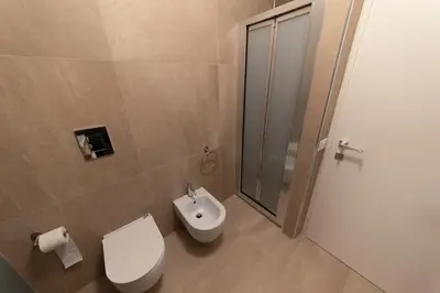 a bathroom with a toilet and a sink and a shower at Alta Marea Sea Apartments in Balestrate