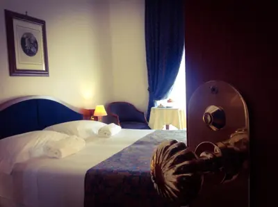 a hotel room with a bed with towels on it at Massimo Plaza Hotel in Palermo