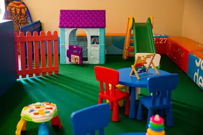 a play room with chairs and a play set at Hotel Punta Nord Est in Castellammare del Golfo