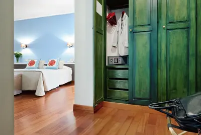 a room with a green closet with a bed at Hotel Al Madarig in Castellammare del Golfo