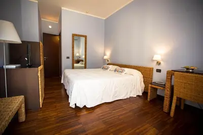 a hotel room with a bed and a mirror at Hotel Cetarium in Castellammare del Golfo