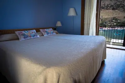 a bedroom with a large bed with a large window at Hotel Cetarium in Castellammare del Golfo