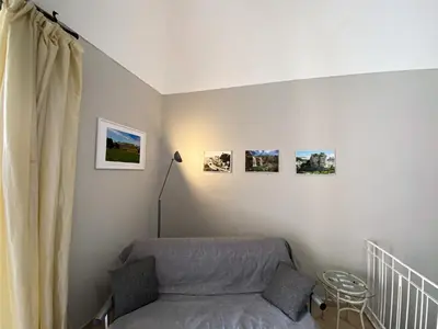 a bedroom with a bed and pictures on the wall at La Ginestra in Corleone