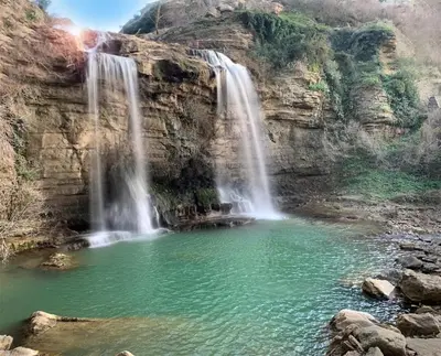 a waterfall in a canyon with a pool of water at La Ginestra in Corleone
