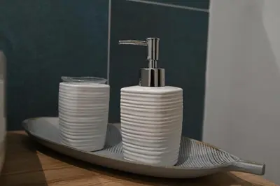 a plate with a faucet and stacks of toilet paper at Terra Sinus Luxury apartment in Terrasini