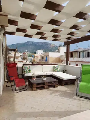 a patio with a couch and chairs and a table at Terra Sinus Luxury apartment in Terrasini