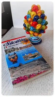 a stack of books and a vase of balloons at Casa il Bergamotto in Palermo