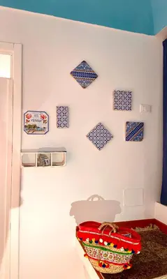 a room with blue and white tiles on the wall at Casa vacanze stella marina in Trappeto