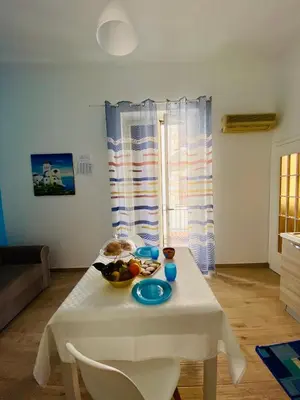 a white table with a bowl of fruit on it at Casa vacanze stella marina in Trappeto