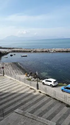 a white car parked next to a body of water at Casa vacanze stella marina in Trappeto