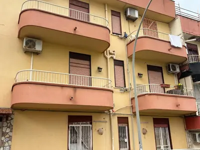 a tall building with balconies and windows on it at Casa Maria Costa Blu in Isola delle Femmine