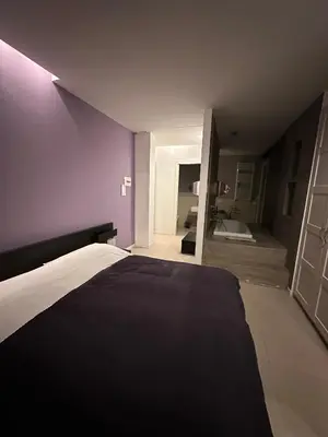 a bedroom with a bed and a purple wall at Malusi B&B in Sferracavallo