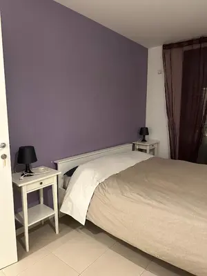 a bedroom with a bed and two tables with lamps at Malusi B&B in Sferracavallo