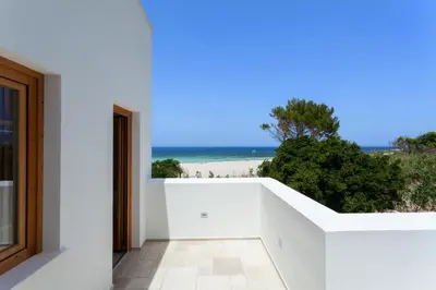 a white house with a view of the beach at Zizha Suite sul mare - San Vito Lo Capo in San Vito lo Capo