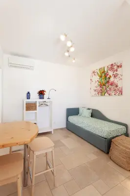 a living room with a couch and a table at Zizha Suite sul mare - San Vito Lo Capo in San Vito lo Capo