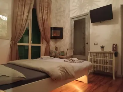 a bedroom with a large bed and a window at Studio Sedie Volanti in Palermo