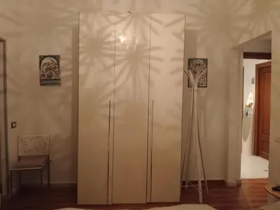 a large white cabinet in a living room at Studio Sedie Volanti in Palermo