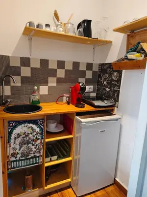 a small kitchen with a counter and a refrigerator at Studio Sedie Volanti in Palermo