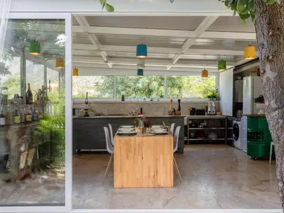 a dining room and kitchen with a table and a tree at Holiday Home Quirat by Interhome in Terrasini