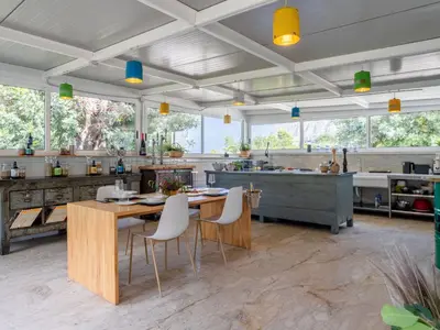 a large kitchen with a wooden table and chairs at Holiday Home Quirat by Interhome in Terrasini