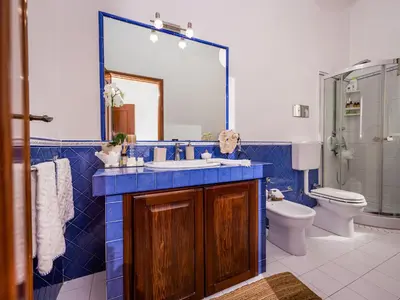 a bathroom with a sink and a toilet and a mirror at Apartment Casa dei Mori by Interhome in Terrasini