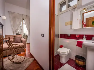 a bathroom with a toilet and a sink and a mirror at Apartment Casa dei Mori by Interhome in Terrasini