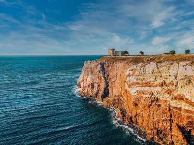 a building on top of a cliff next to the ocean at Apartment Casa dei Mori by Interhome in Terrasini