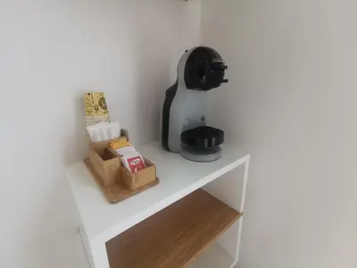 a coffee maker sitting on a white shelf in a room at Maqueda Mood in Palermo