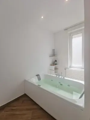 a white bathroom with a large tub in a room at Maqueda Mood in Palermo