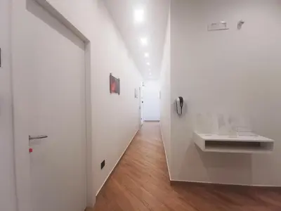 a hallway with white walls and a wooden floor at Maqueda Mood in Palermo