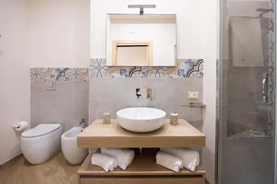a bathroom with a sink and a toilet at Kalatafimi- Palermo Apartment 2 Camere & Wi-Fi in Palermo