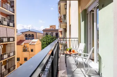 a balcony with chairs and a view of a city at Kalatafimi- Palermo Apartment 2 Camere & Wi-Fi in Palermo