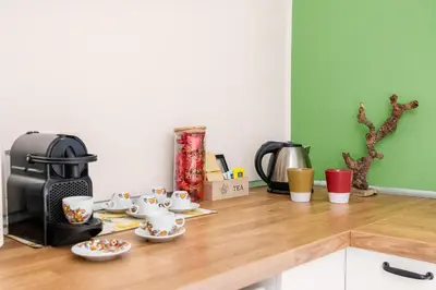a kitchen counter with cups and saucers on it at Kalatafimi- Palermo Apartment 2 Camere & Wi-Fi in Palermo