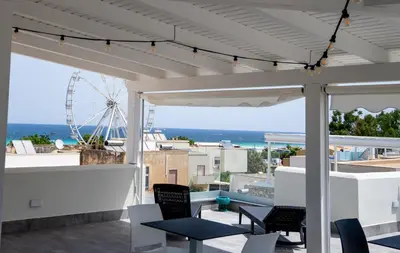 a patio with chairs and a view of the ocean at B&B il Colibrì in San Vito lo Capo