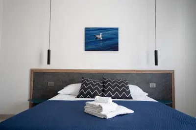 a bedroom with a bed with towels on it at B&B il Colibrì in San Vito lo Capo