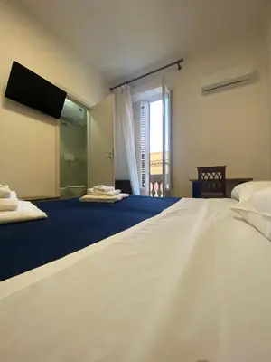 a large bedroom with two beds and a window at 38 Aira Hotels in Palermo