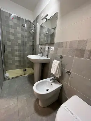 a bathroom with a sink and a toilet and a shower at 38 Aira Hotels in Palermo