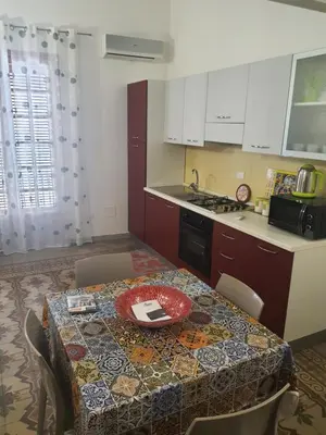 a kitchen with a table with a plate on it at Casa vacanza Raggio di Sole in Castellammare del Golfo
