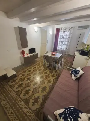 a living room with a couch and a table at Casa vacanza Raggio di Sole in Castellammare del Golfo