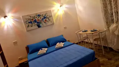 a small bedroom with a blue bed and a table at Le Terre di Sicilia in Terrasini