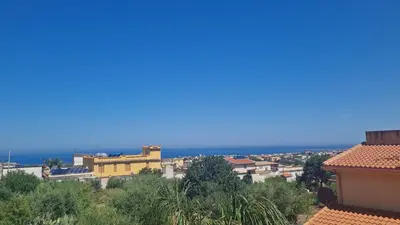 a view of a city with the ocean in the background at Le Terre di Sicilia in Terrasini