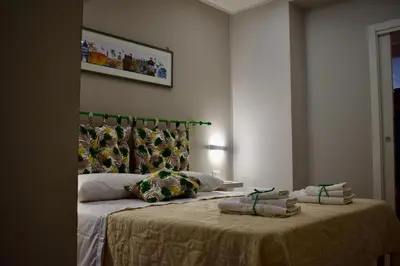 a bedroom with a bed with two pillows on it at La Casa Dei Leoni Di Sicilia in Palermo