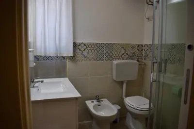 a bathroom with a sink and a toilet and a shower at La Casa Dei Leoni Di Sicilia in Palermo