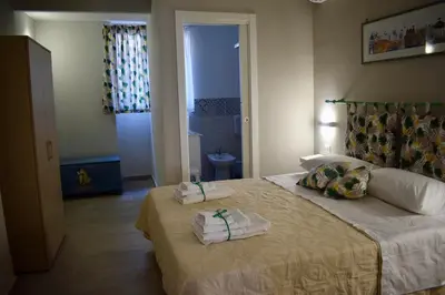 a bedroom with a bed with two towels on it at La Casa Dei Leoni Di Sicilia in Palermo