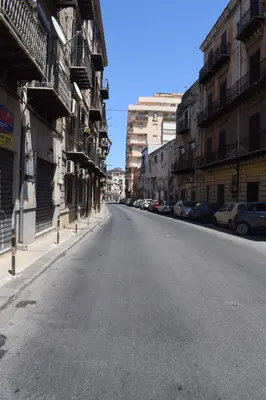 an empty street in a city with buildings at La Casa Dei Leoni Di Sicilia in Palermo