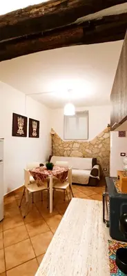 a living room with a table and a couch at Ai Normanni in Palermo