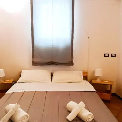 a bedroom with a bed with two towels on it at Ai Normanni in Palermo